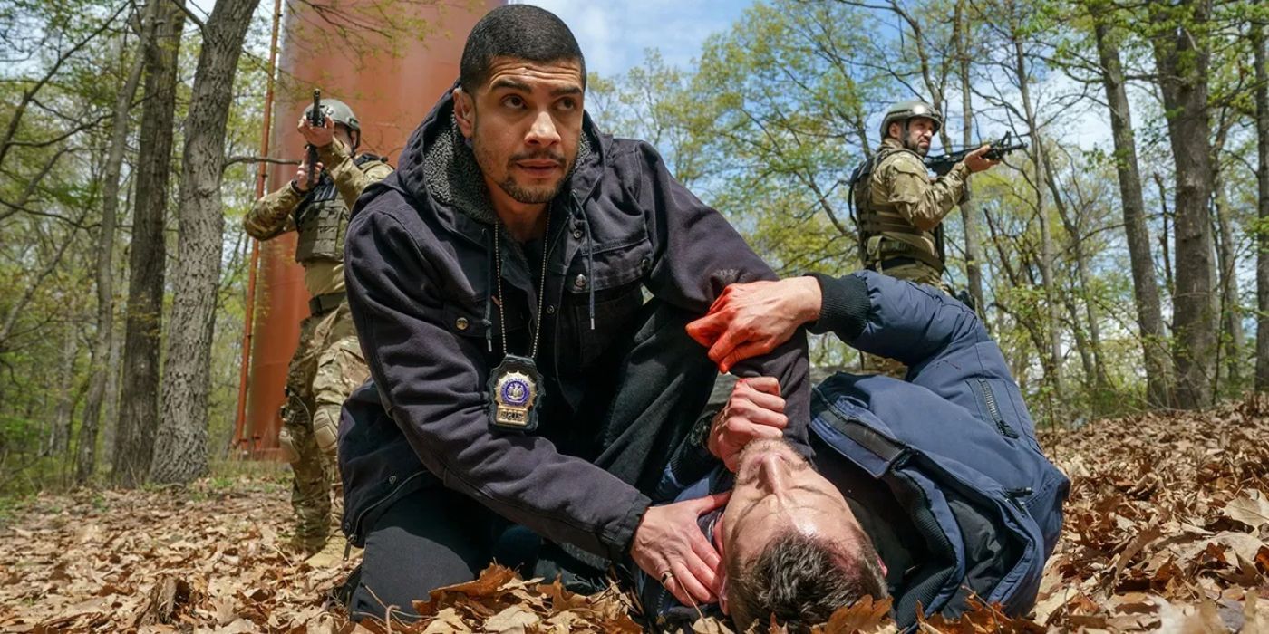 Bobbie Reyes (Rick Gonzalez) holding Jamie Whelan (Brent Antonello) on the ground after he's shot in Law and Order Organized Crime.