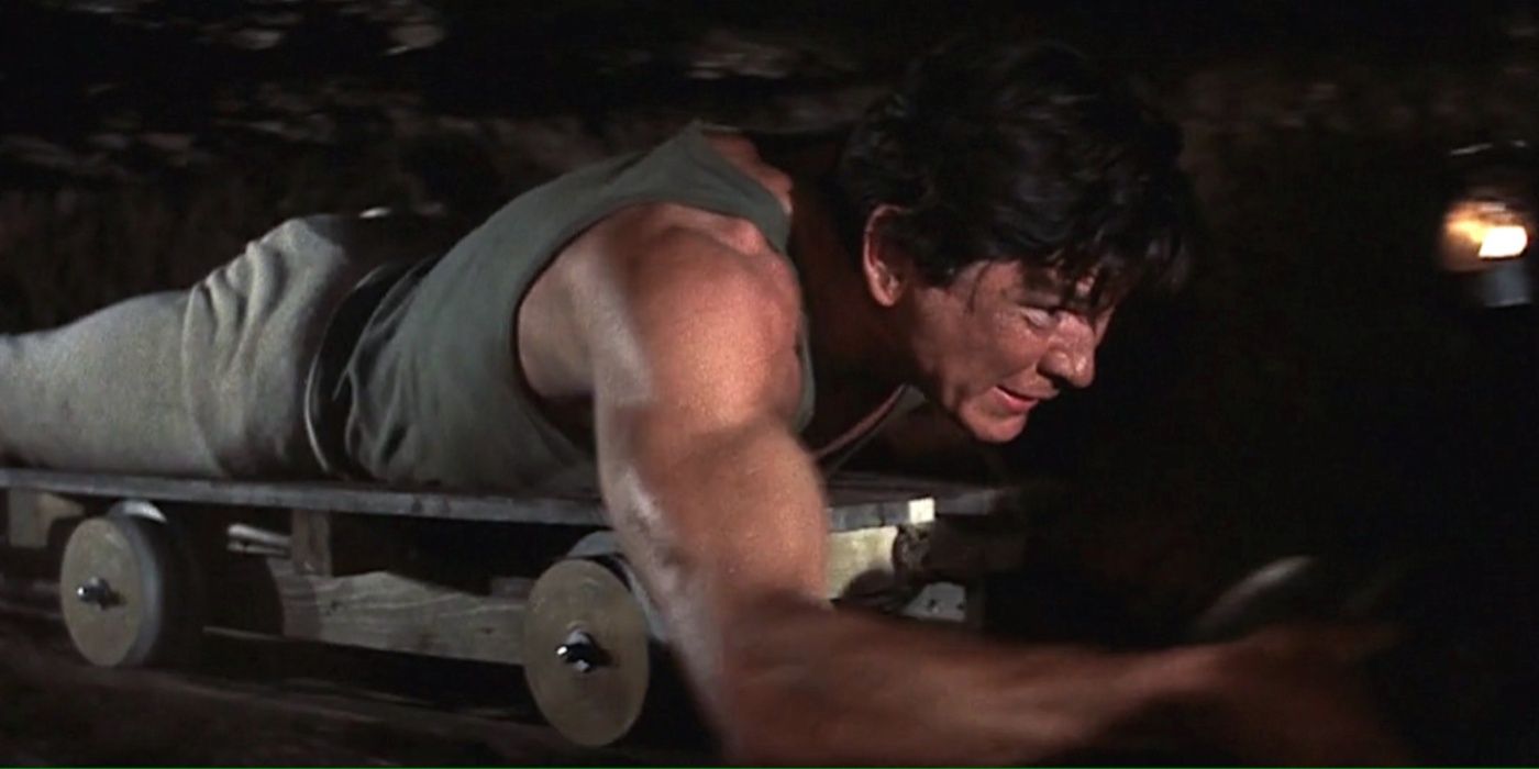 Charles Bronson as  Flight Lieutenant Danny Welinski, a.k.a. the “Tunnel King,” pulling himself through a tunnel in The Great Escape