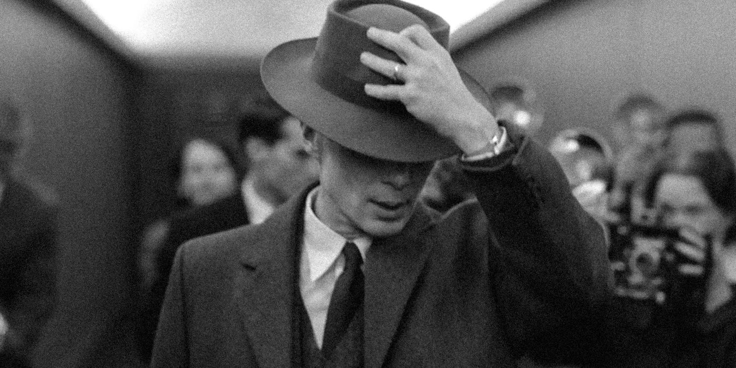 Cillian Murphy as J. Robert Oppenheimer in Oppenheimer holding his hat 