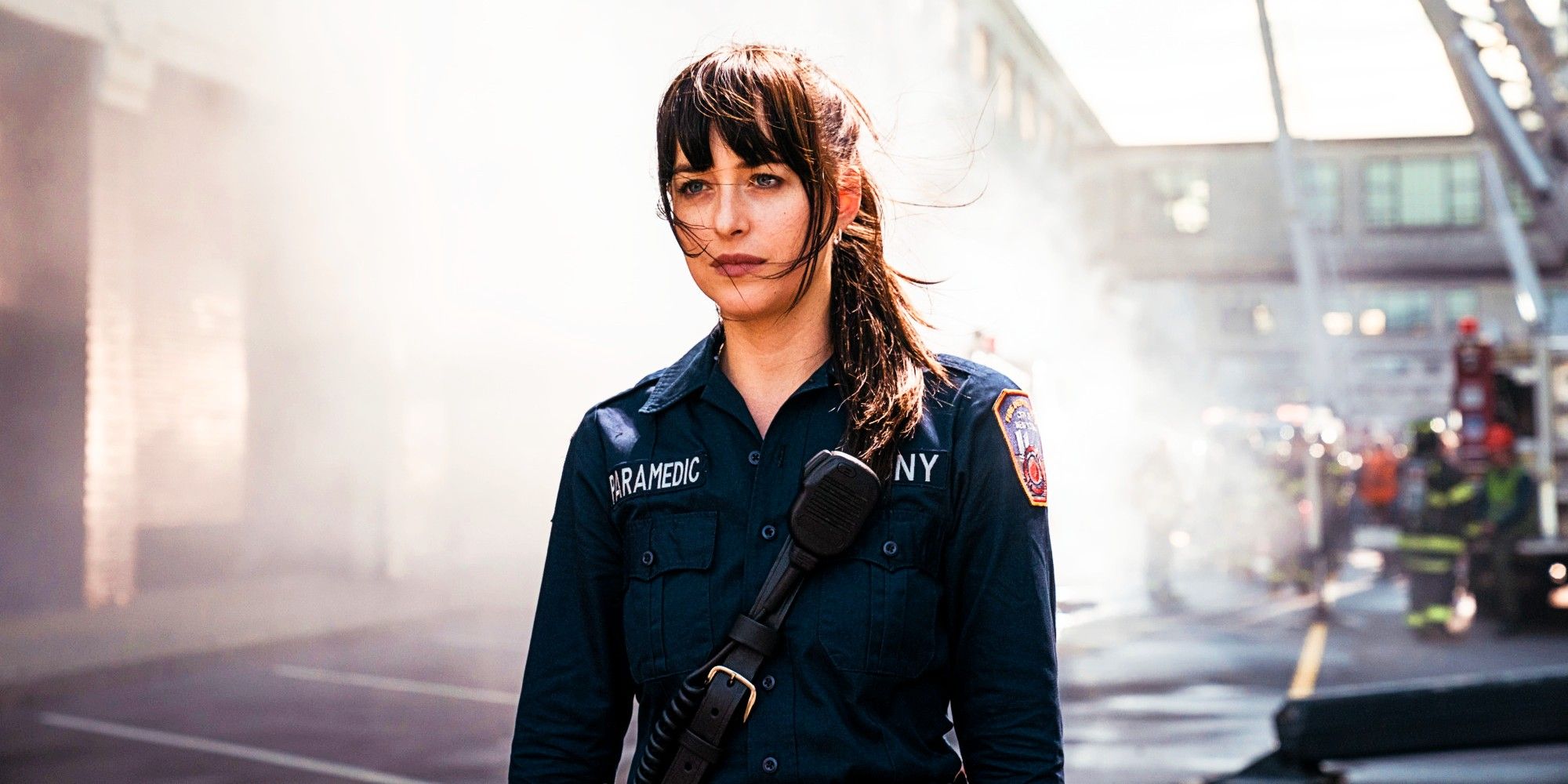 Dakota Johnson as Cassandra Web In Paramedic Uniform With Crisis Scene In The Background In Madame Web