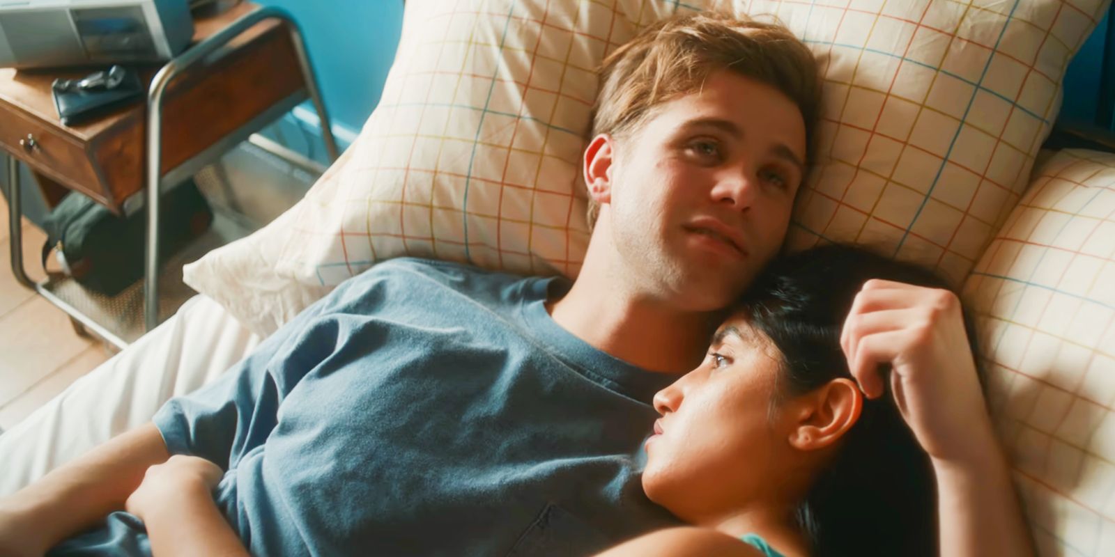 Dex playing with Emma's hair while holding her in bed in One Day