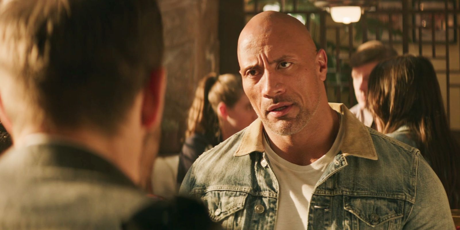 Dwayne Johnson as Luke Hobbs with a concerned look on his face in Hobbs & Shaw