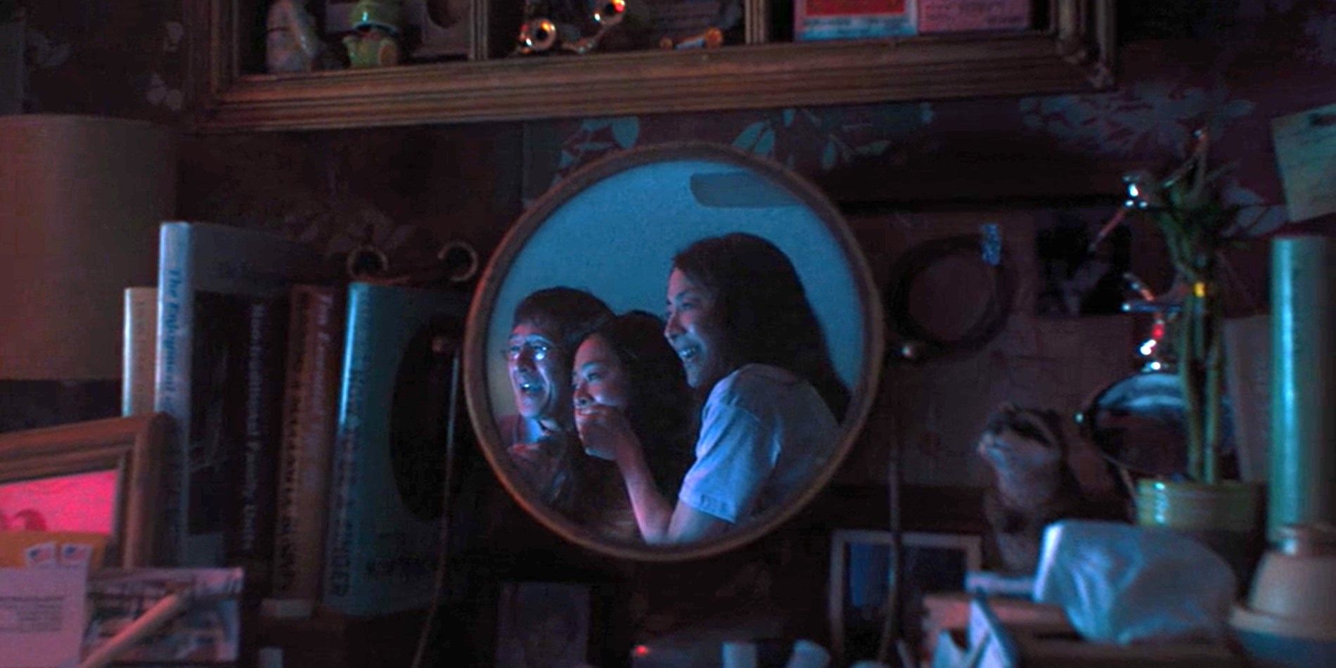 The opening shot from Everything Everywhere All At Once, showing Evelyn, Joy, and Waymond Wang laughing together in a mirror