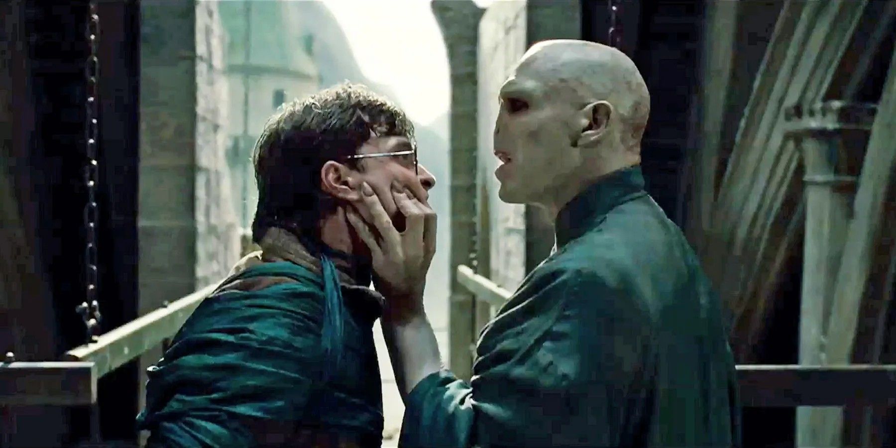 Ralph Fiennes como Voldemort agarra o rosto de Harry Potter (Daniel Radcliffe) em Harry Potter e as Relíquias da Morte - Parte 2