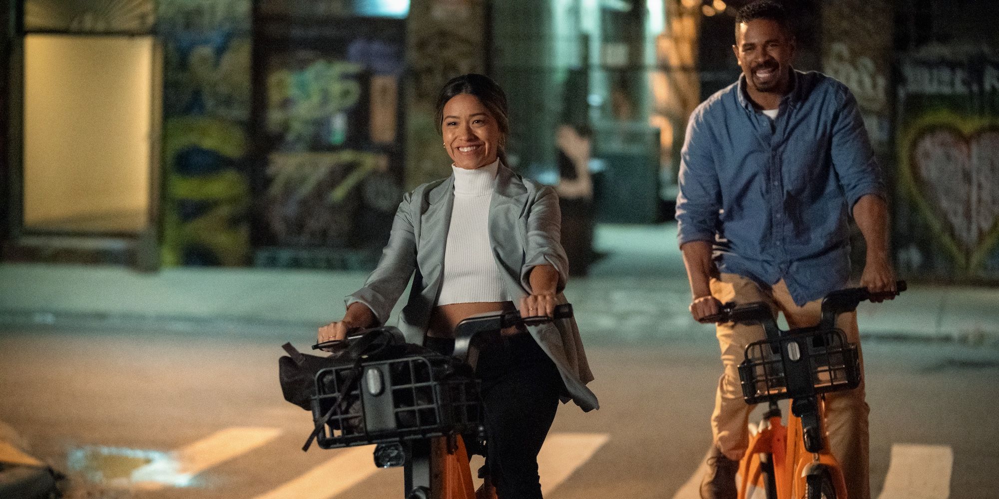 Gina Rodriguez and Damon Wayans Jr ride bikes in Players