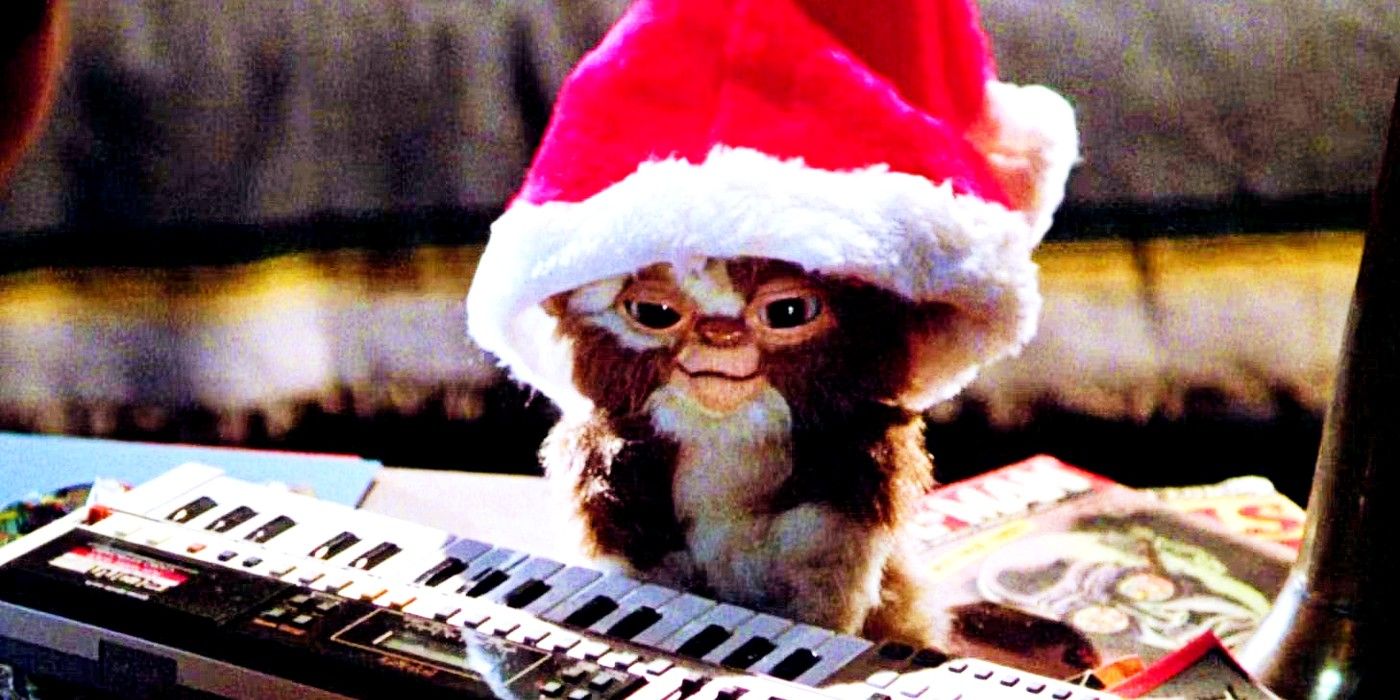 Gizmo wearing a Santa hat and sitting next to an electric keyboard