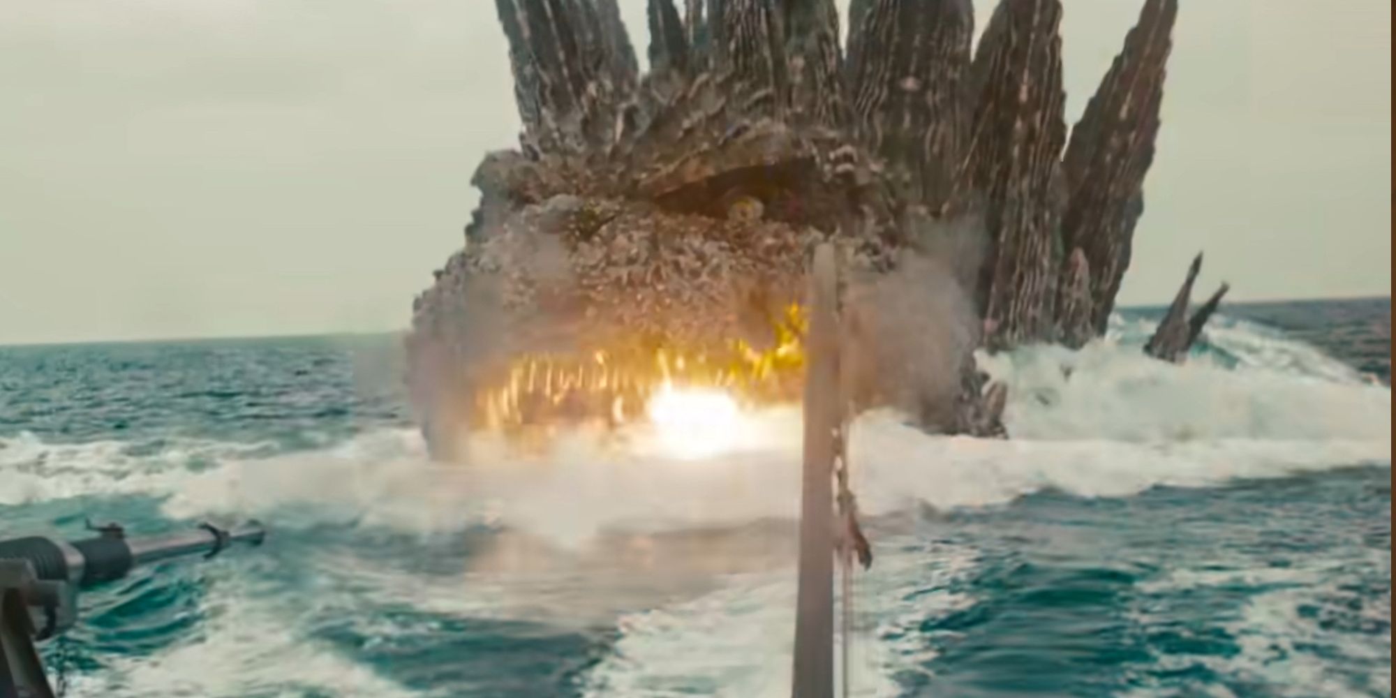 Godzilla charging forward in the water with a fireball in his mouth in Godzilla Minus One