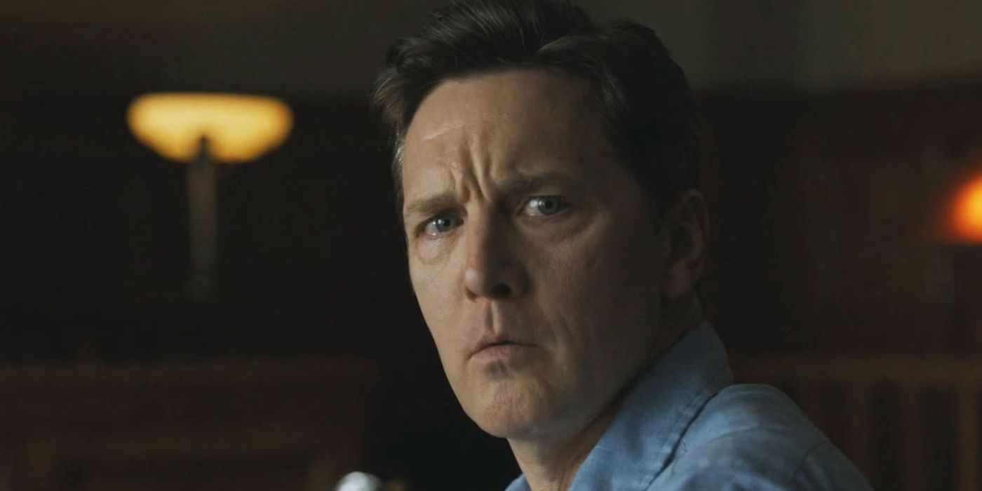 Hank Asher (Andrew McCarthy) looking tired with a tear in his eye in The Family.