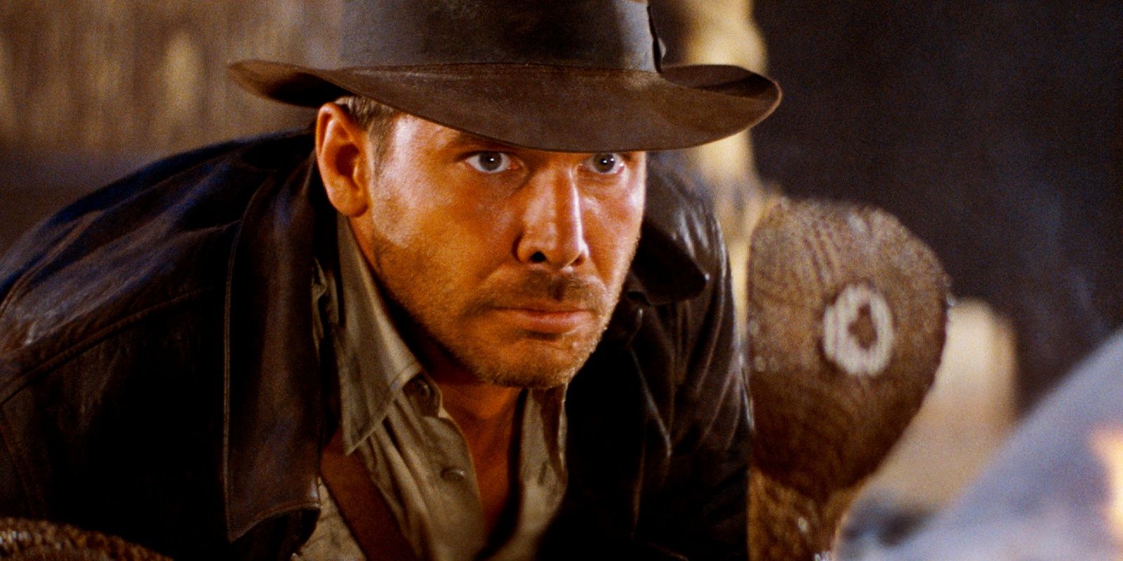 Harrison Ford as Indiana Jones terrified as he looks at a cobra in Raiders of the Lost Ark