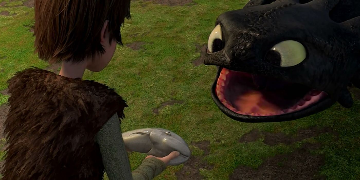 HIccup giving Toothless a fish in How to Train Your Dragon
