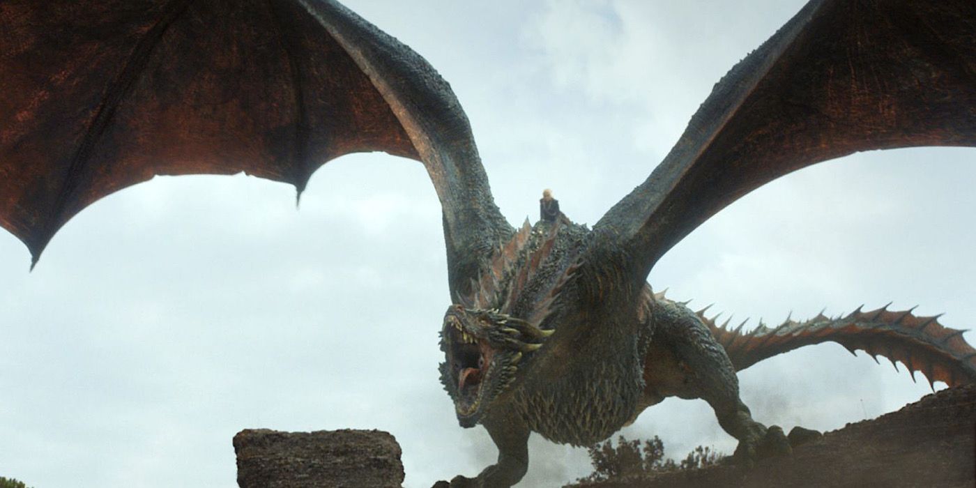 Drogon perches on a building and roars in a scene from Game of Thrones.