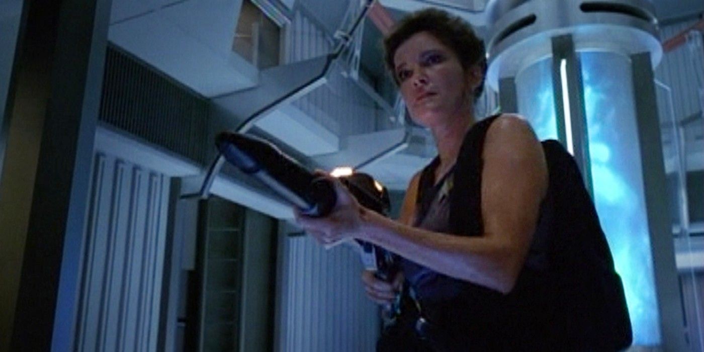 Captain Janeway aims a phaser rifle in Engineering in the Star Trek: Voyager episode 