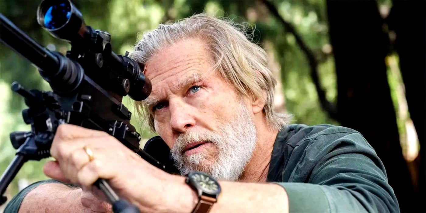Jeff Bridges holding and aiming his gun in The Old Man