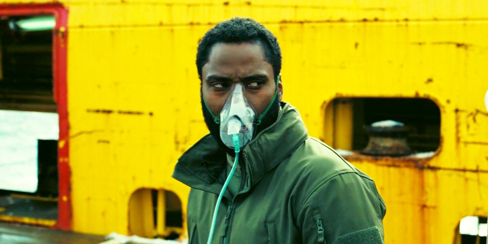 John David Washington wearing an oxygen mask as the Protagonist in Tenet