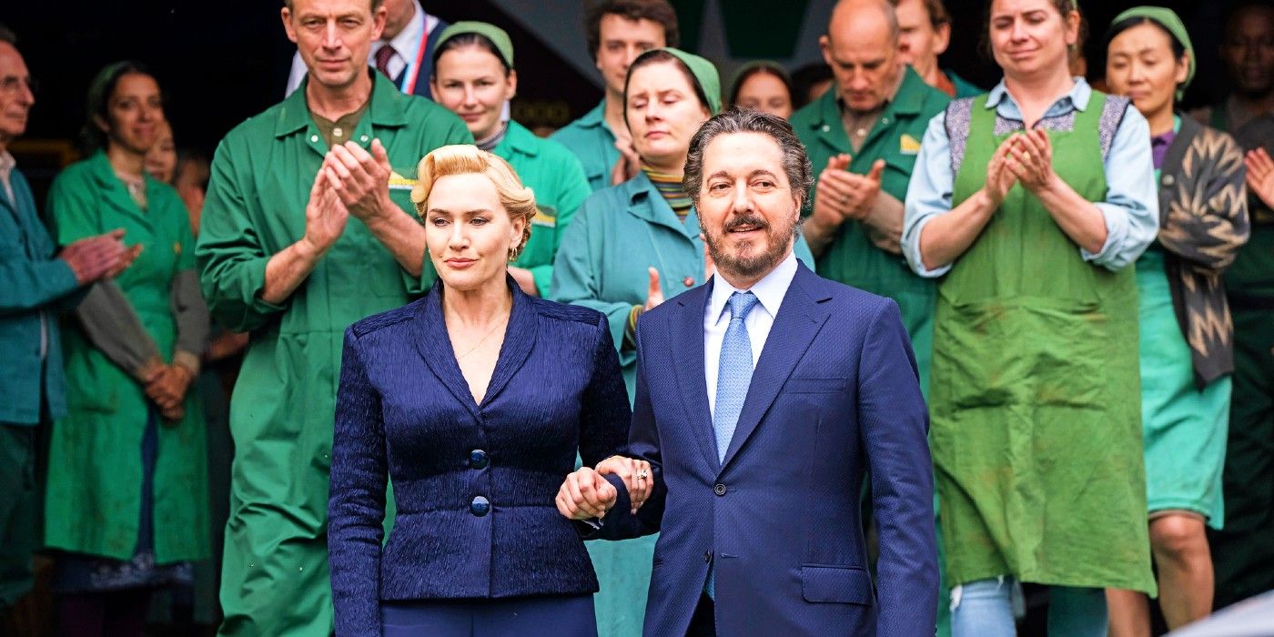 Kate Winslet as Elena and Guillaume Gallienne as Nicolas holding hands in The Regime