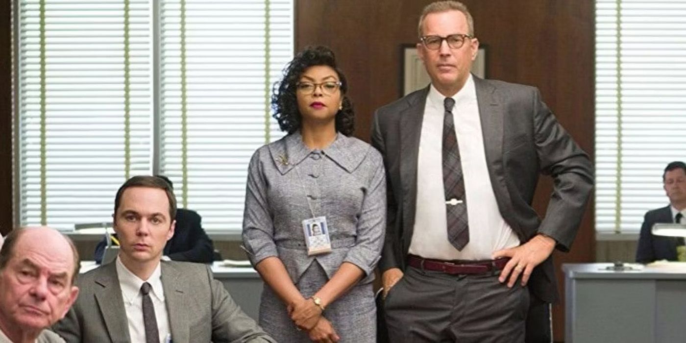 Katherine Johnson (Taraji P. Henson) and Al Harrison (Kevin Costner) stand at the head of the table in Hidden Figures