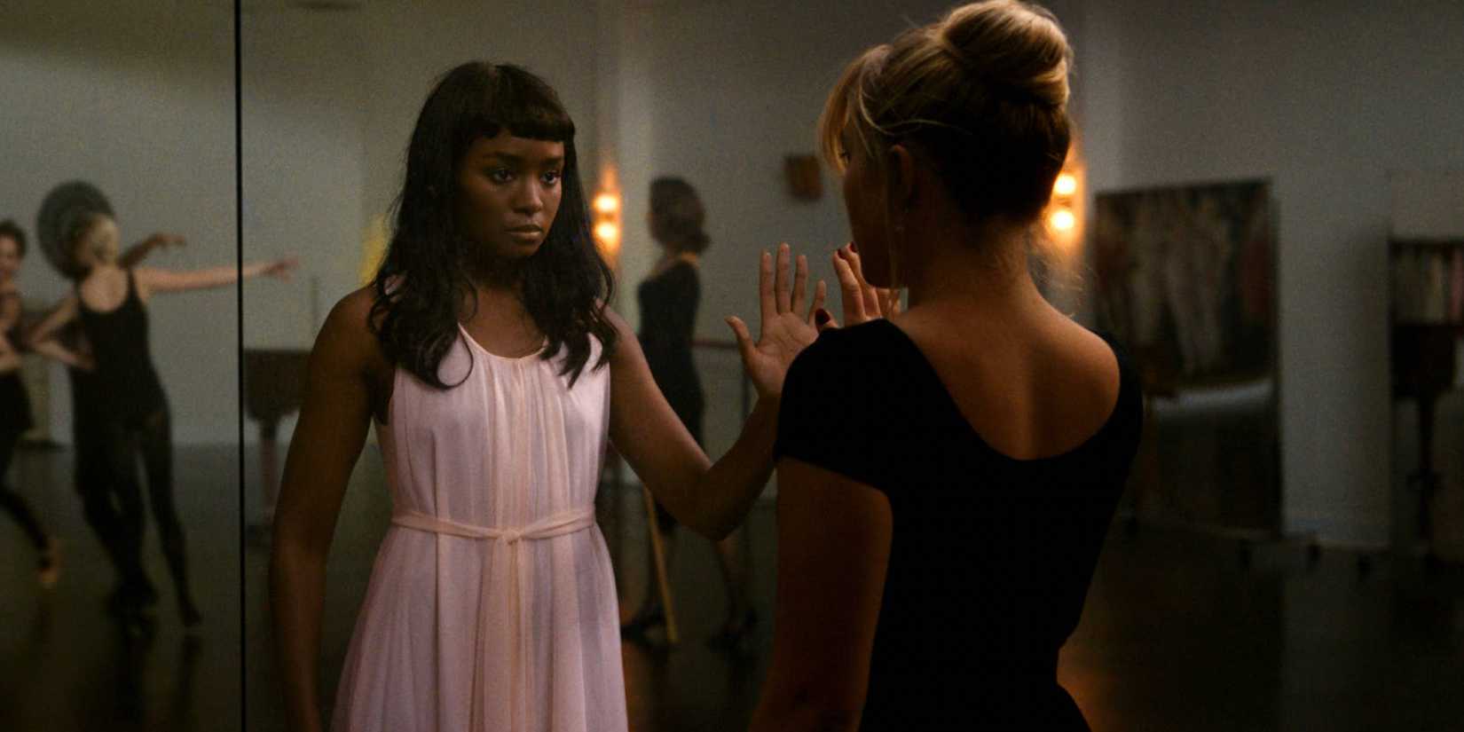 Kiki Layne appearing across from Florence Pugh in a mirror in a dance studio in Dont Worry Darling