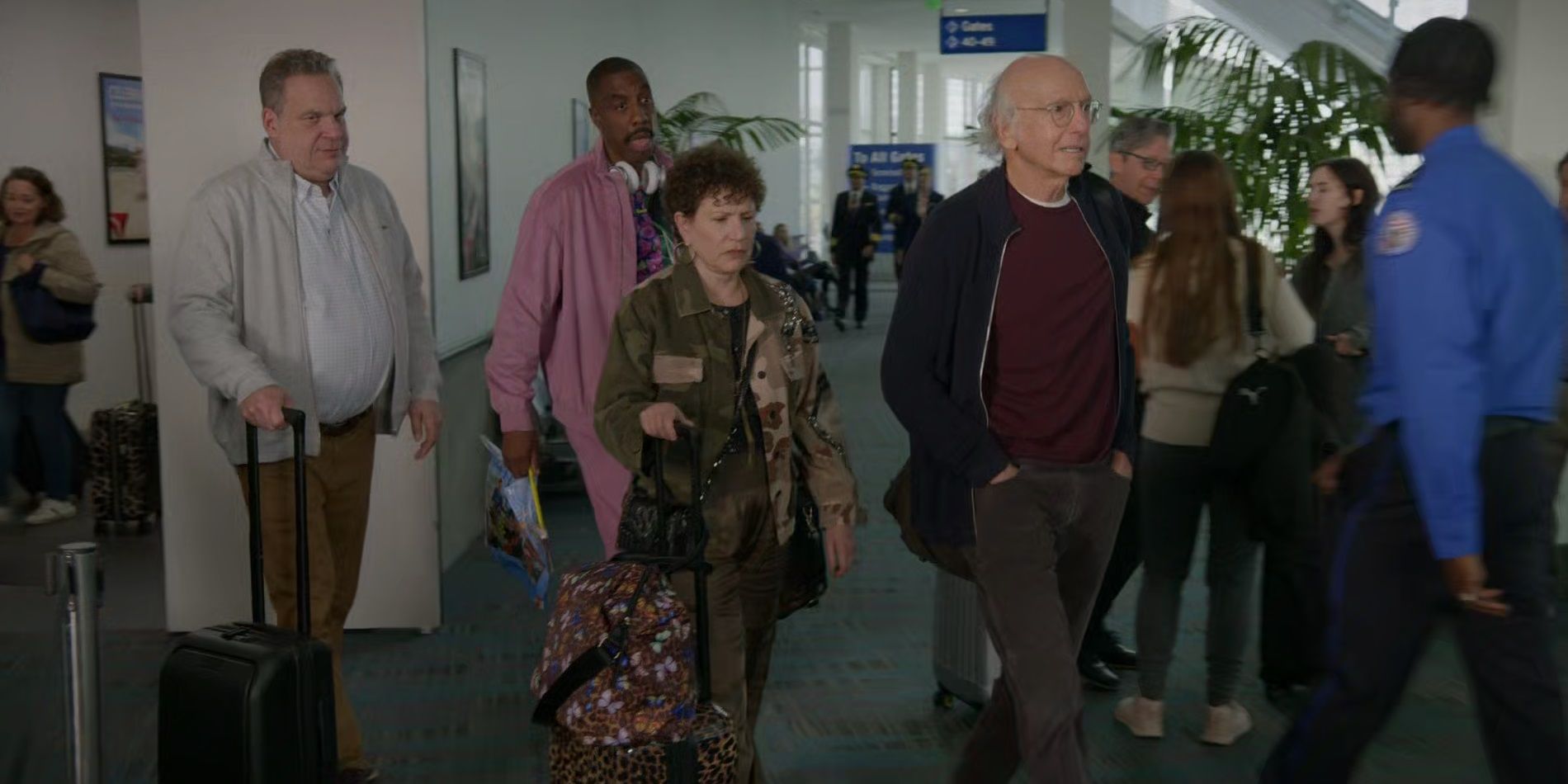 Larry, Jeff, Susie, and Leon at the airport in Curb Your Enthusiasm