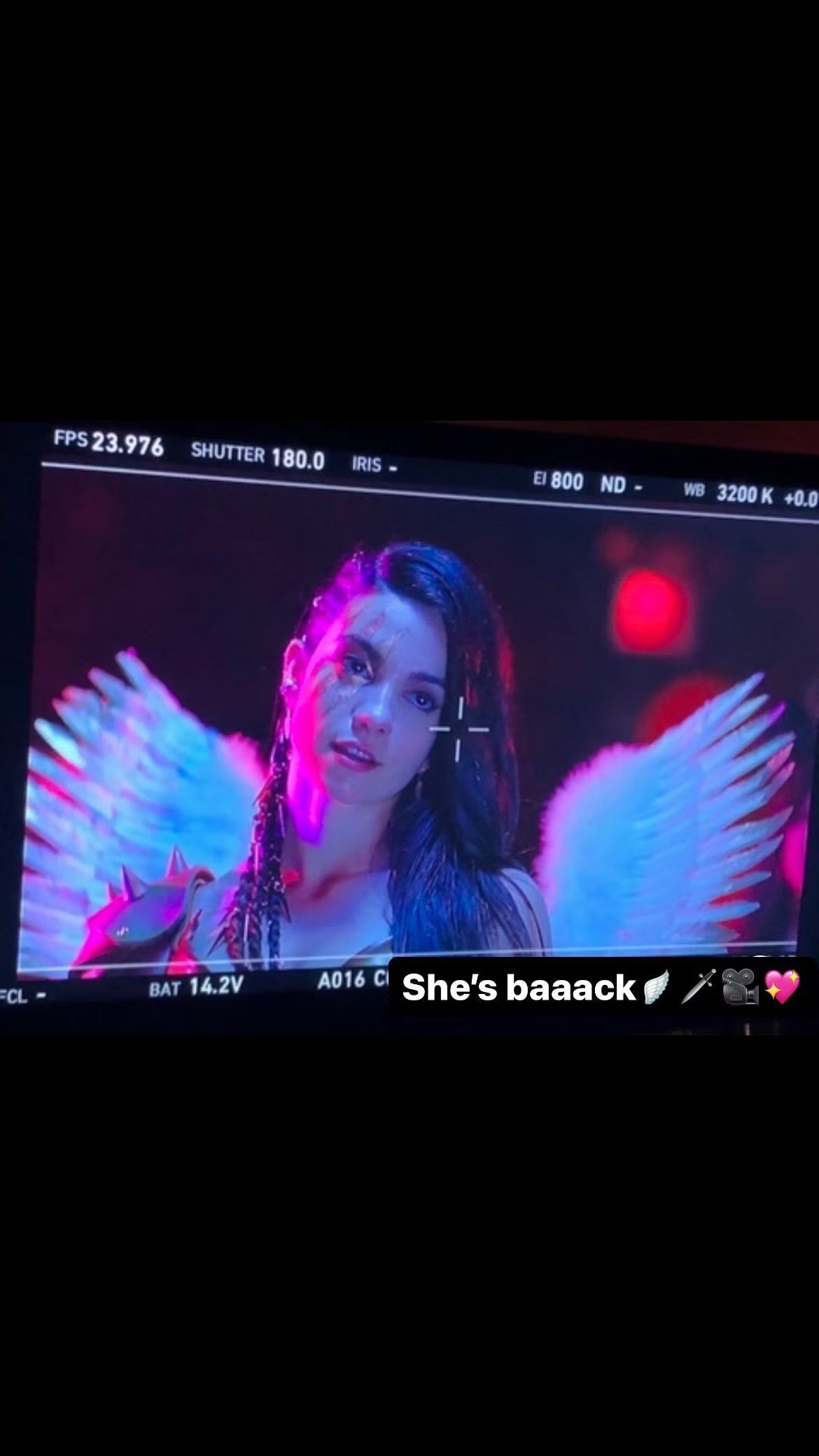 A photo of a monitor image showing Lauren LaVera wearing a winged warrior costume with spiked shoulder pads in a scene from Terrifier 3