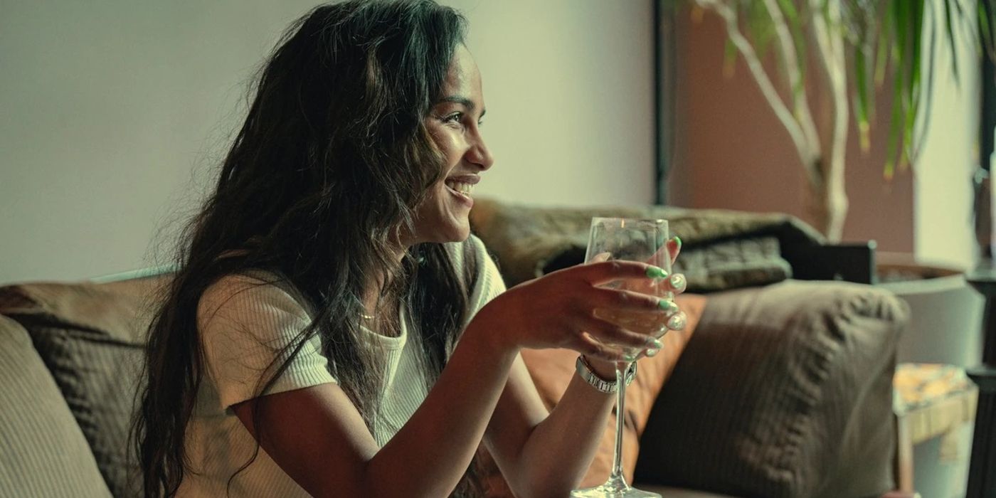 Lauryn Lawrence (Saffron Hocking) holding a wine glass and laughing in Top Boy.