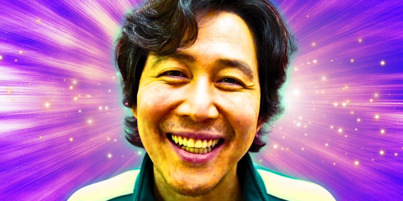 Lee Jung-jae with a large smile on his face as Seong Gi-hun in Squid Game set against a purple background with sparkles scattered around