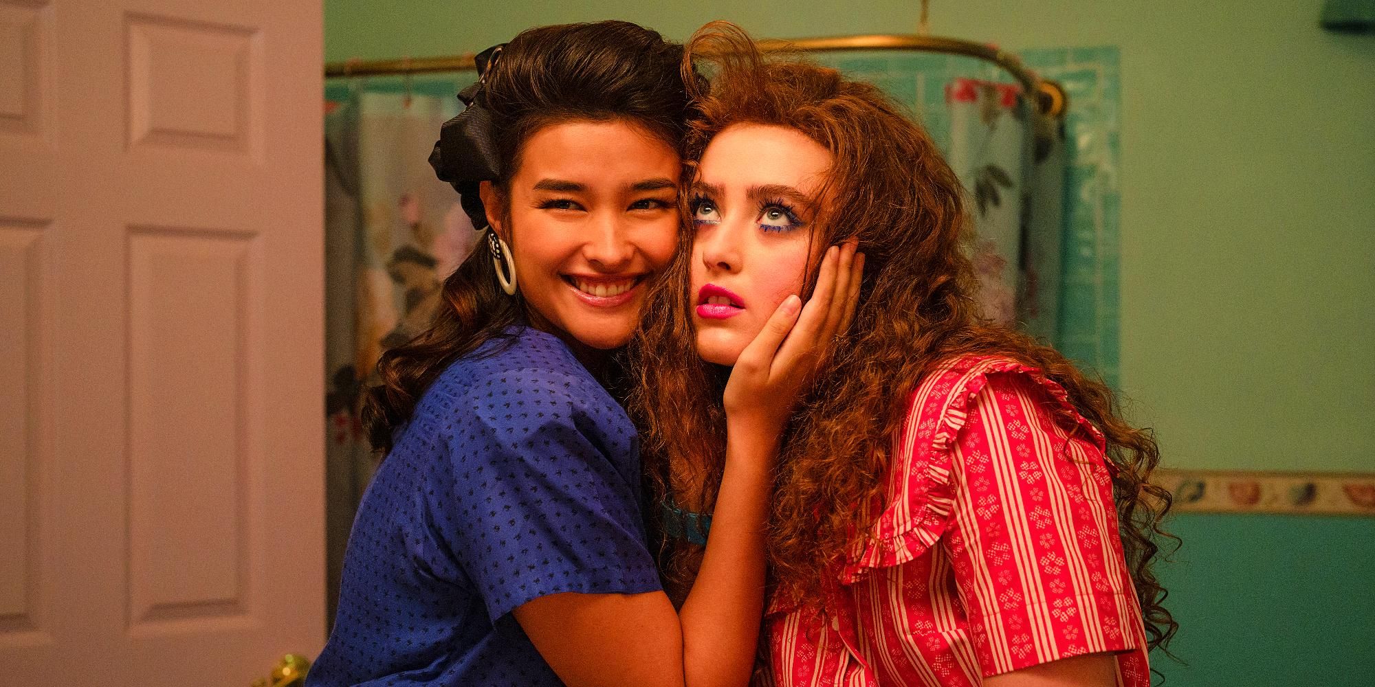 Liza Soberano as Taffy and Kathryn Newton as Lisa Swallows with their cheeks pressed together in Lisa Frankenstein