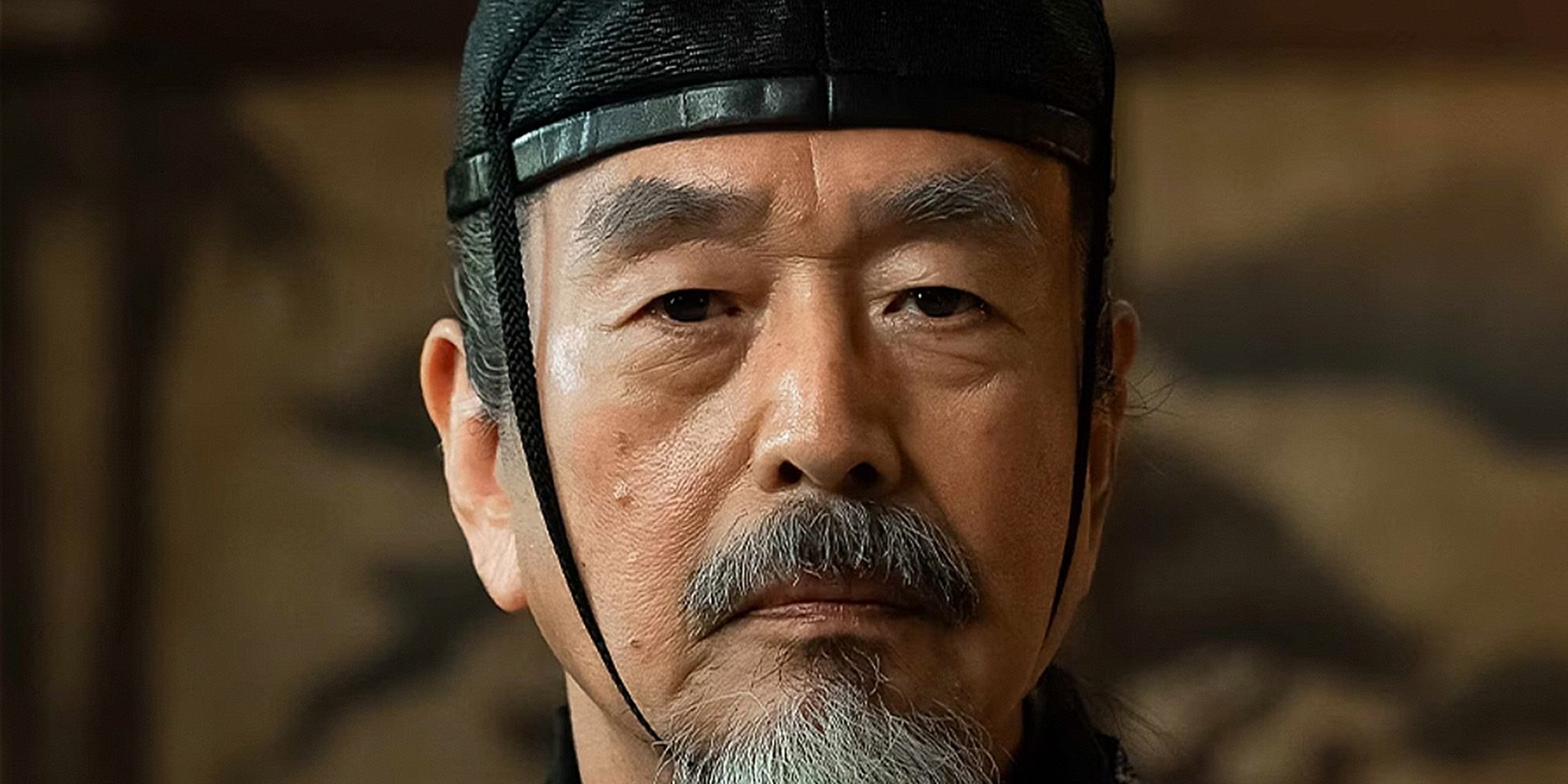 Lord Sugiyama wearning a headpiece while giving a straight stern look in Shogun
