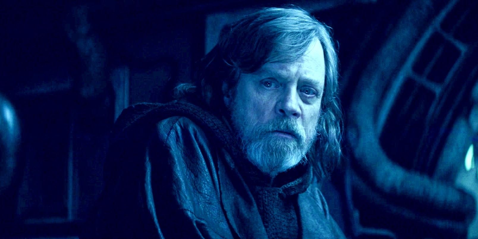Luke Skywalker looking concerned in a blue hue in Star Wars: The Last Jedi.