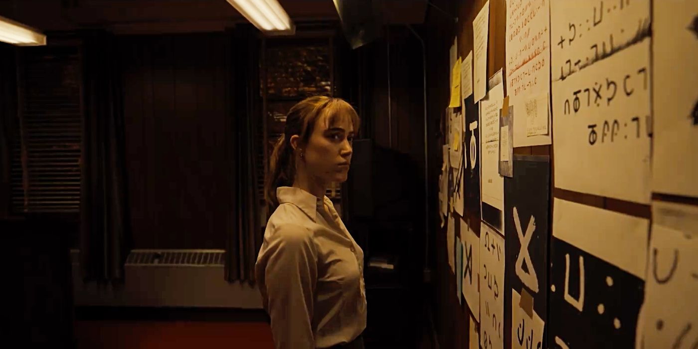 Maika Monroe looking at an evidence board covered in symbols in Longlegs