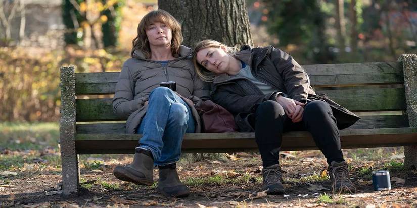 Mare and Lori sitting on a bench in Mare-of-Easttown