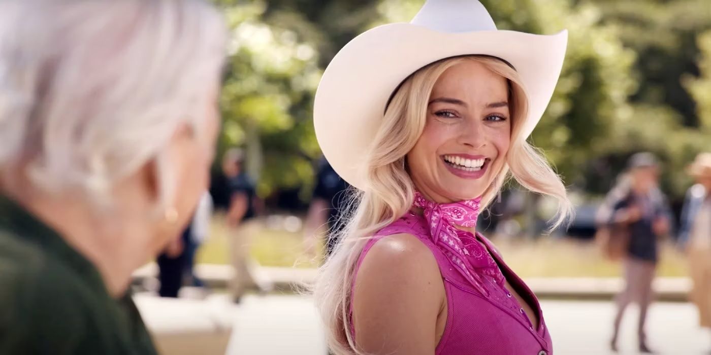 Margot Robbie smiling at the elderly woman while sitting on a bench in Barbie
