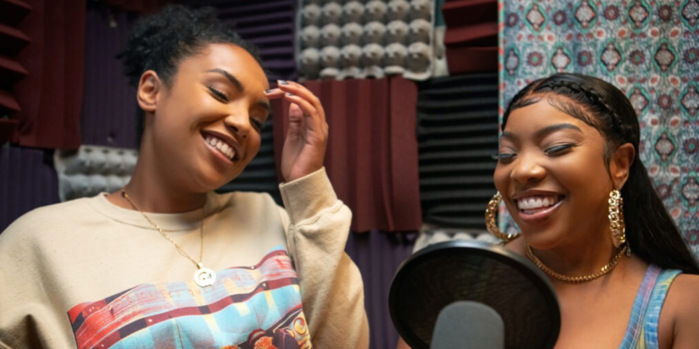 Mia (KaMillion) and Shawna (Aida Osman) smiling and singing in a recording studio in Rap Shit.