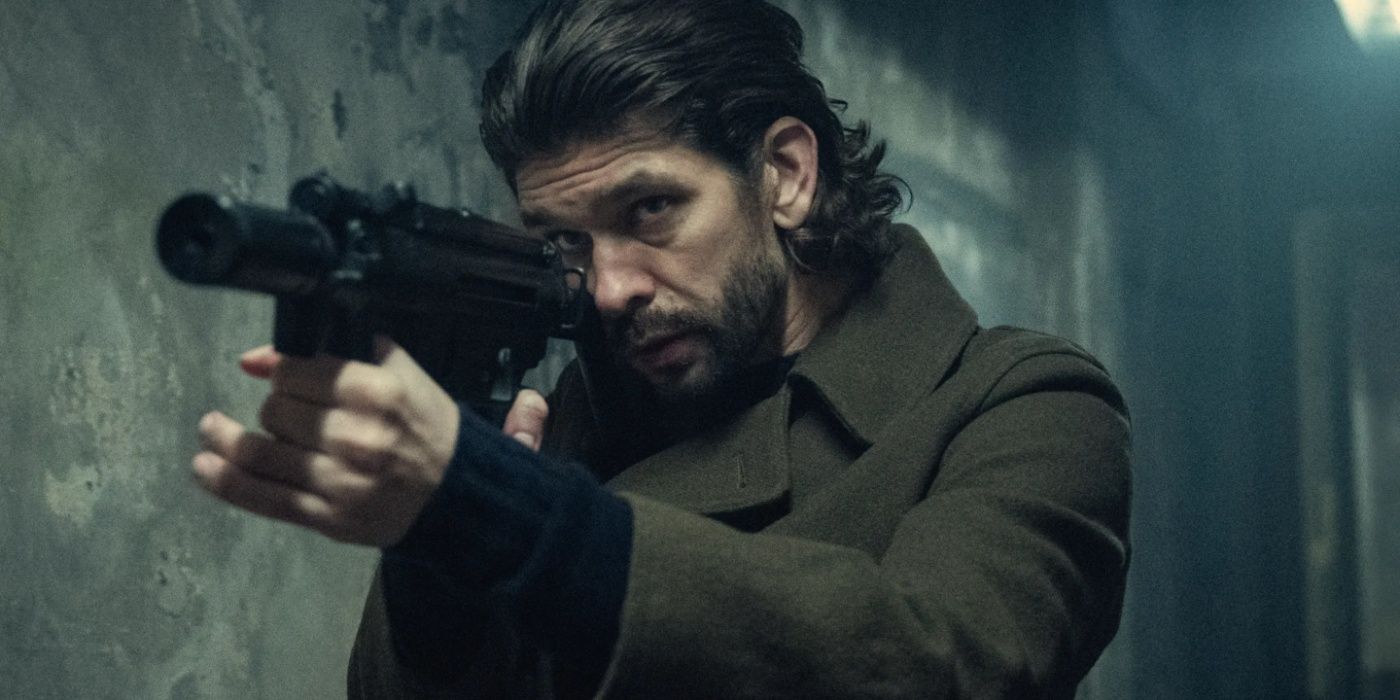 Ben Whishaw pointing a gun in Black Doves