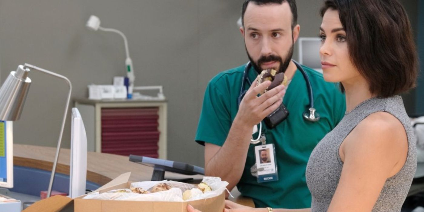 Julian Booth (Jenna Dewan) holds a box of donuts in The Resident