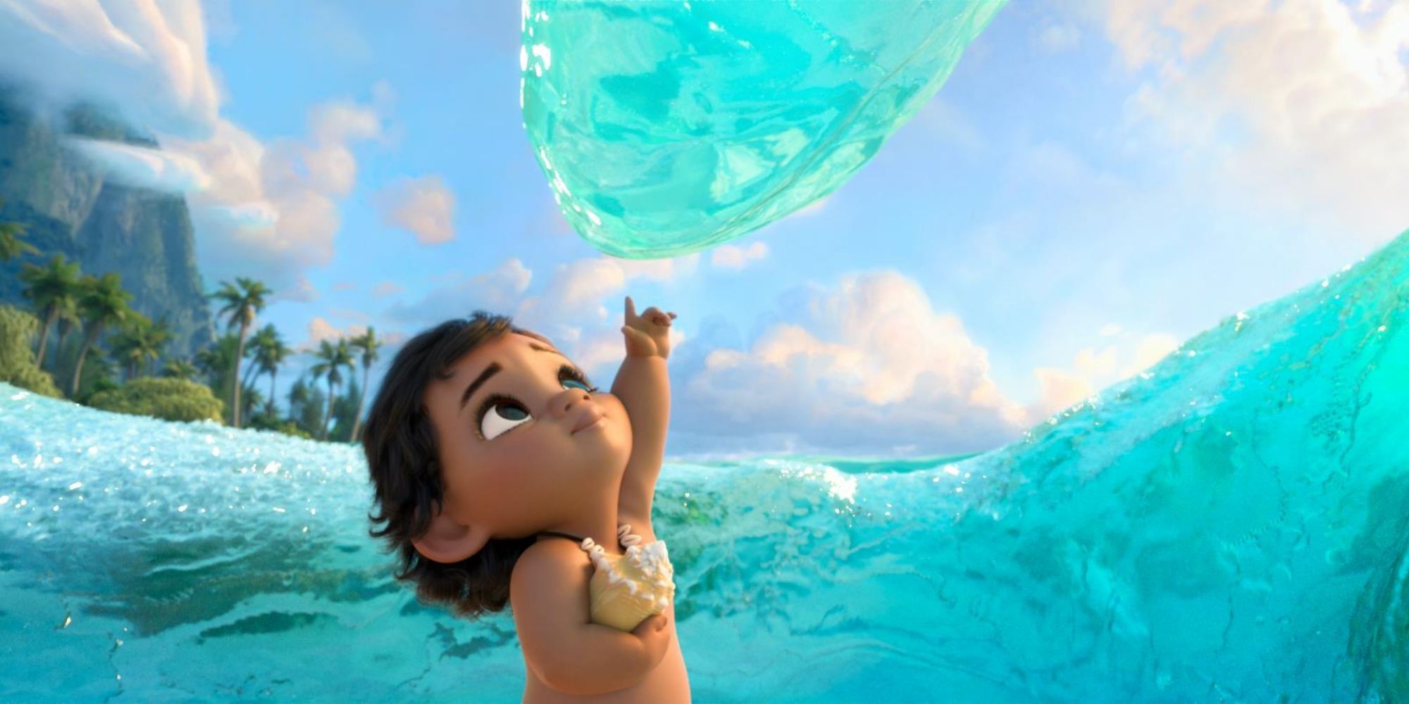 Moana as a baby reaching up to touch the ocean in Moana