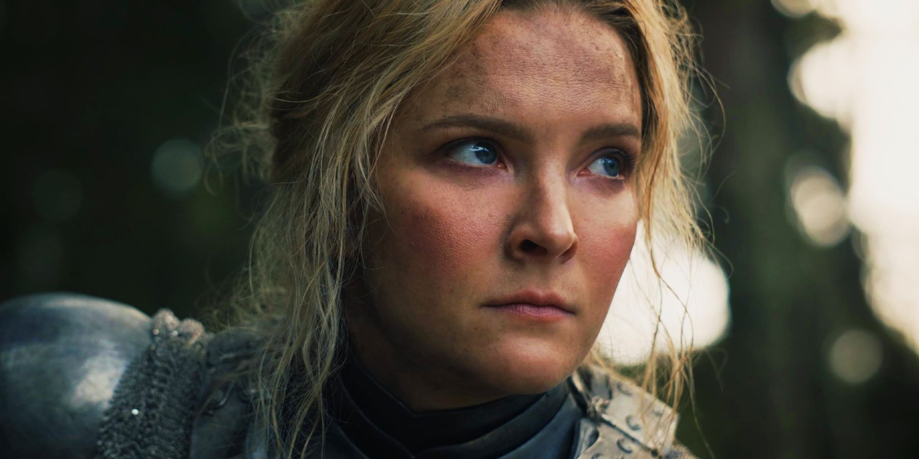 A close-up of Morfydd Clark as Galadriel looking grave in The Rings of Power