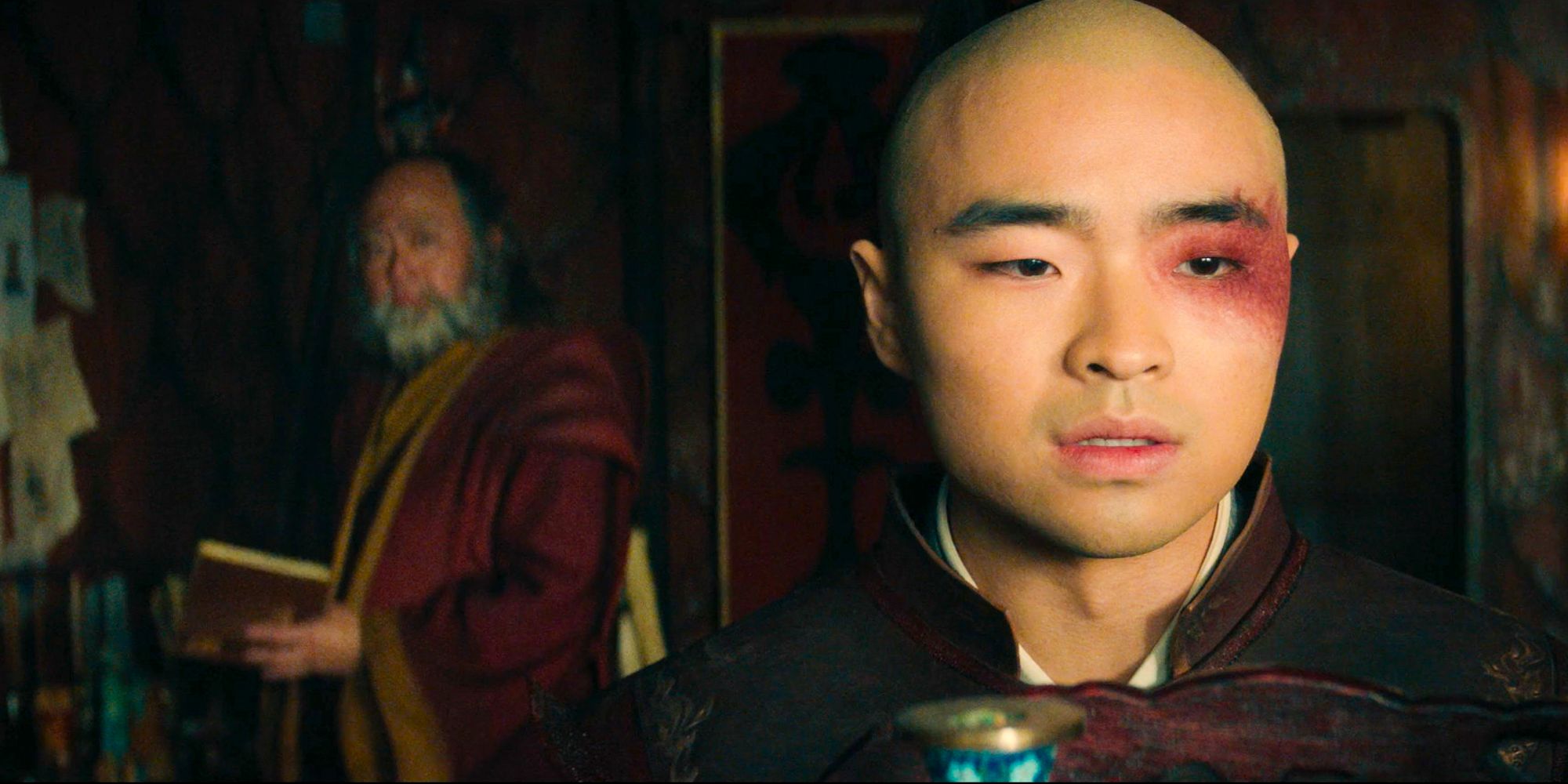 Zuko close up and uncle Iroh in the back from Avatar the last airbender looking gloomy  Dallas James Liu as Zuko Paul Sun-Hyung Lee as Uncle Iroh