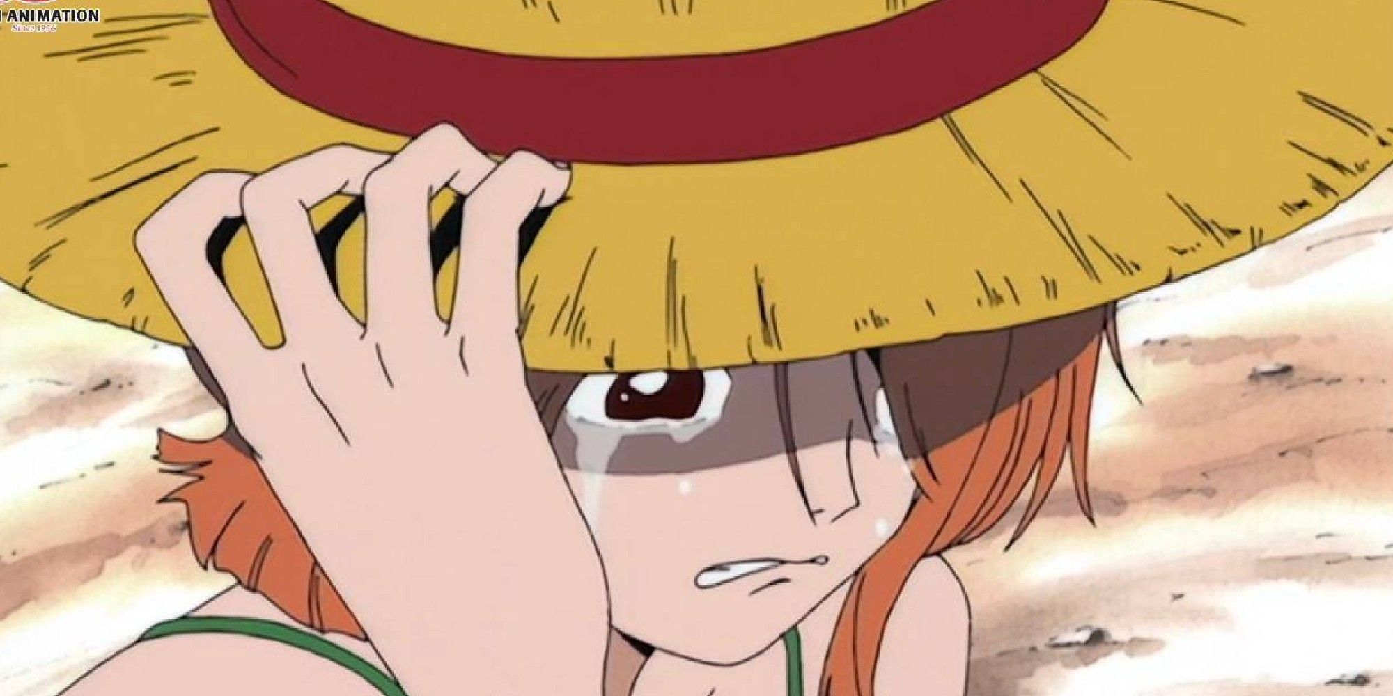 Nami cries after Luffy puts his hat on her head