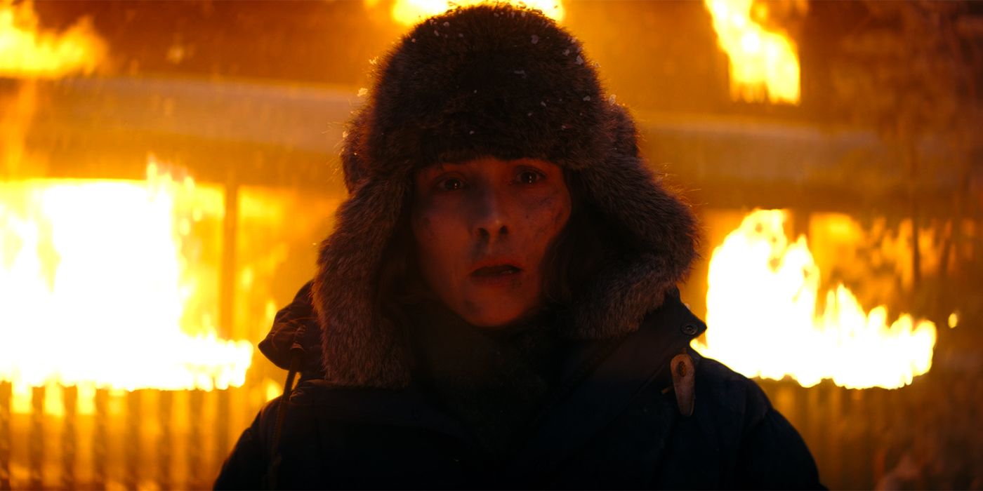 Noomi Rapace as Jo in front of a burning cabin in Constellation-1