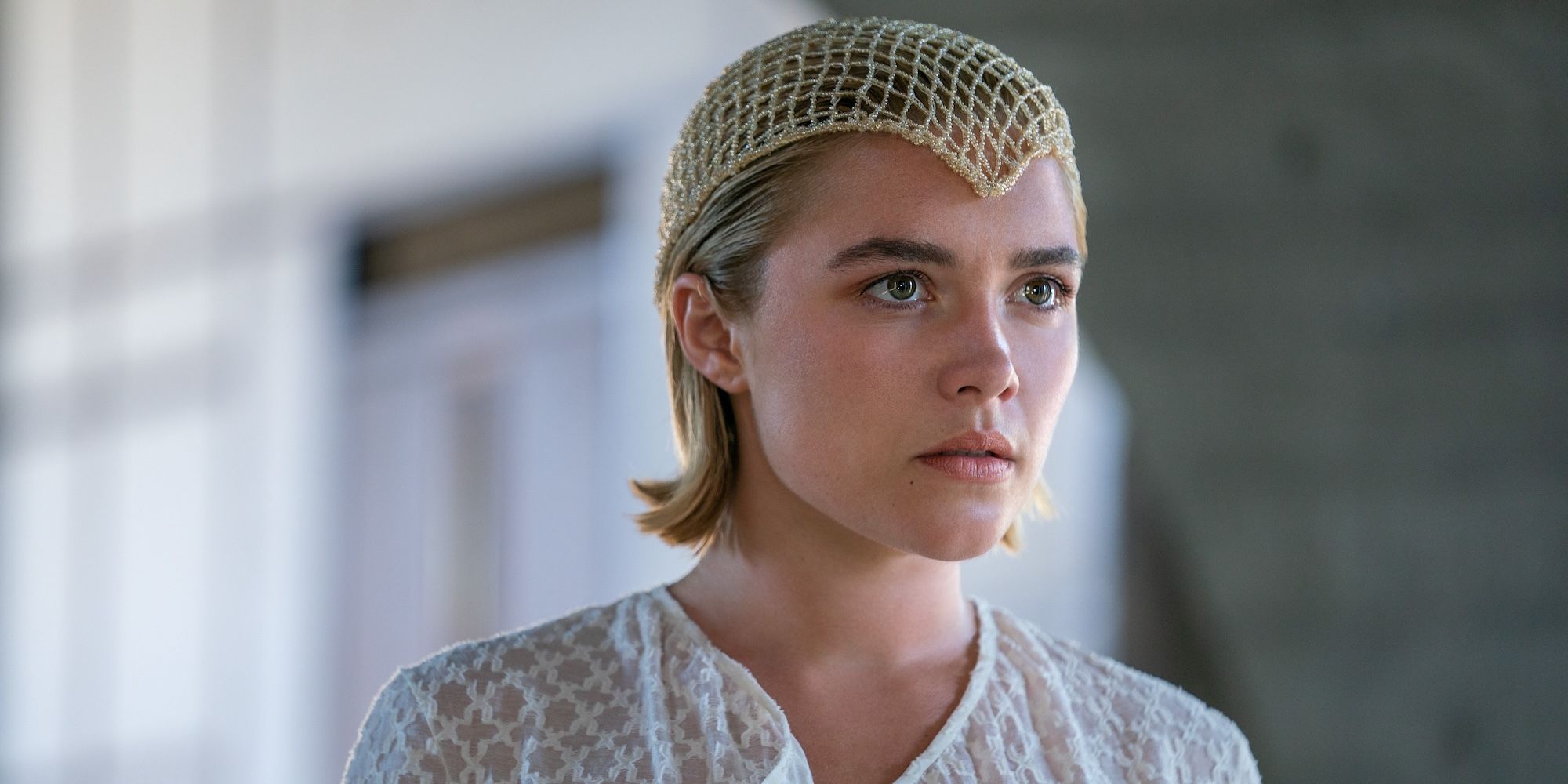 Florence Pugh's Princess Irulan wearing a white blouse and looking concerned in Dune 2