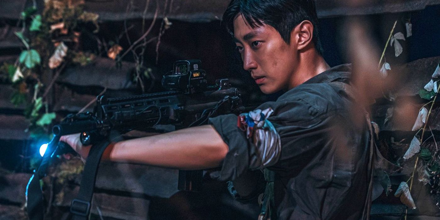 Private Park Chan-yeong (Jinyoung) holding a gun in Sweet Home