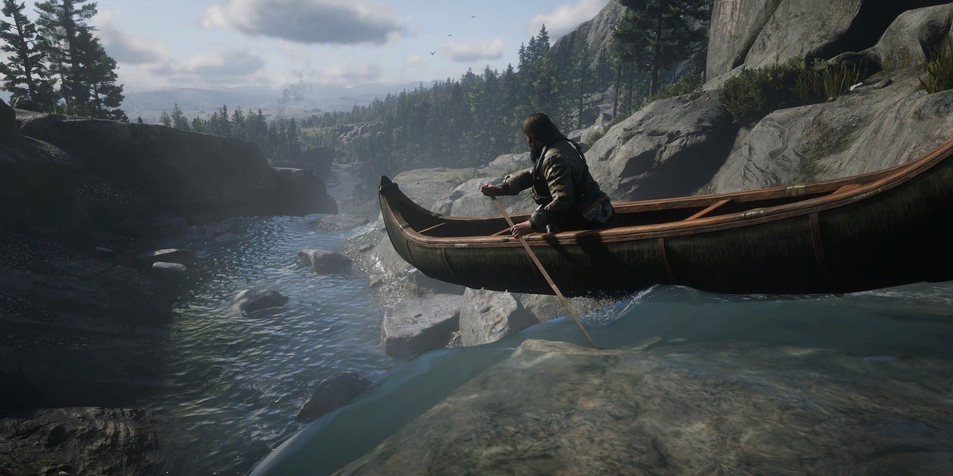 A player character rides a canoe down rocky rapids in a screenshot from Red Dead Redemption 2.