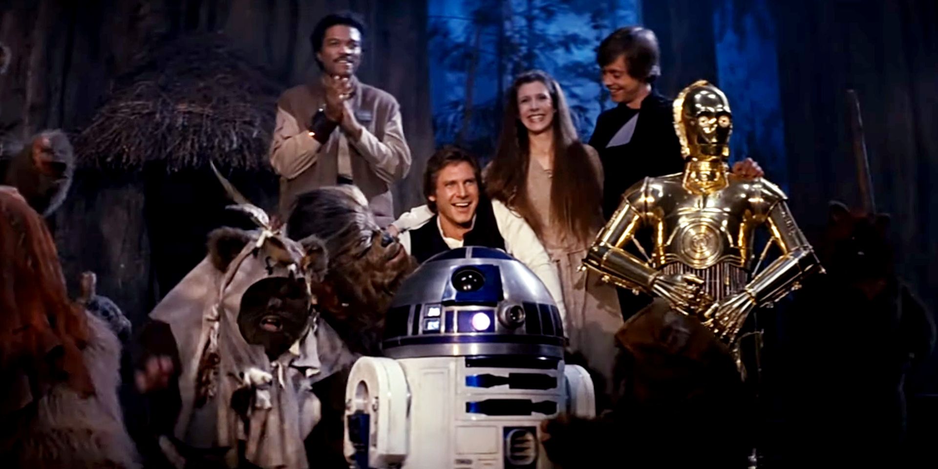Lando, Han, R2, Leia, Luke, Chewbacca, and the Ewoks celebrate their victory at the end of Return of the Jedi