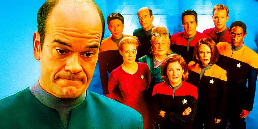 The Doctor (Robert Picardo) from Star Trek: Voyager stands looking embarassed with a promotional shot of the Star Trek: Voyager cast in the background.