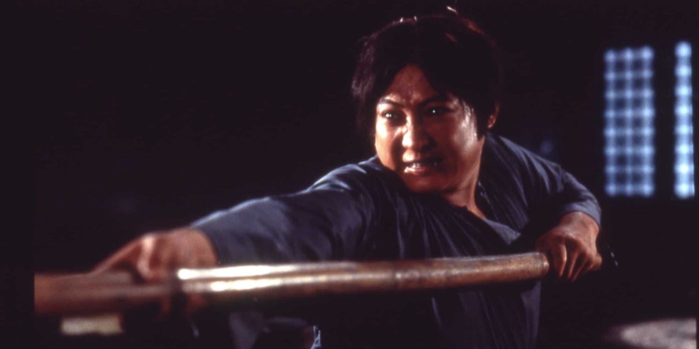 Sammo Hung aims a fighting stick in Encounters of the Spooky Kind 1980