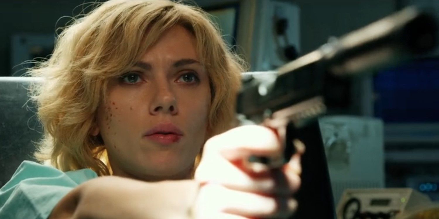 Lucy (Scarlett Johansson) pointing a gun in Lucy