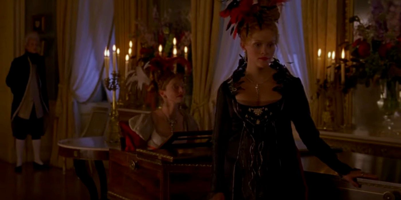 Reese Witherspoon as Becky Sharp standing by a piano in Vanity Fair (2004).