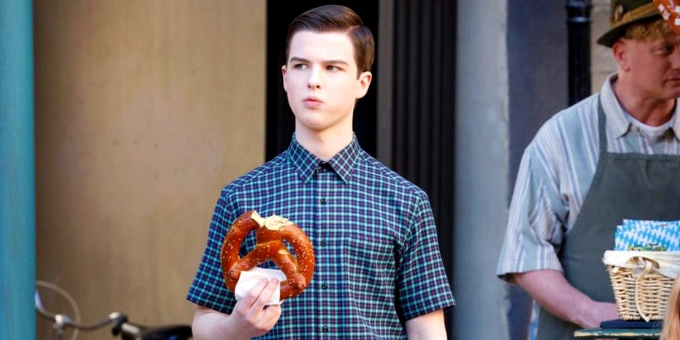 Sheldon eating a pretzel in Germany in Young Sheldon season 7