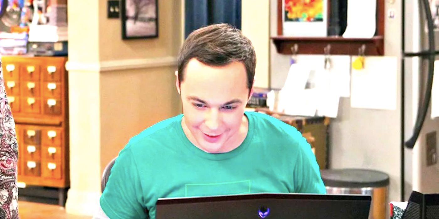 Sheldon smiles at his laptop in The Big Bang Theory