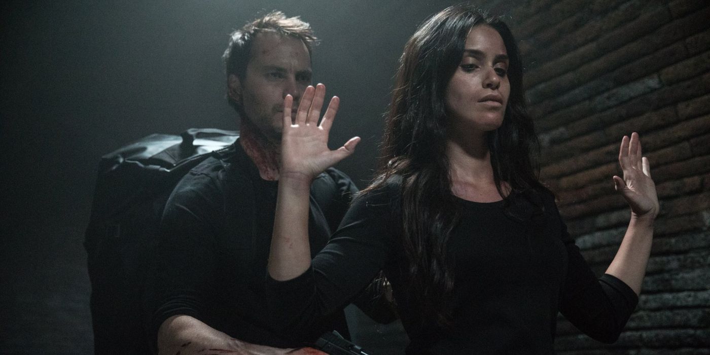 Shiva Negar as Annika being held at gunpoint by Taylor Kitsch's Ghost in American Assassin